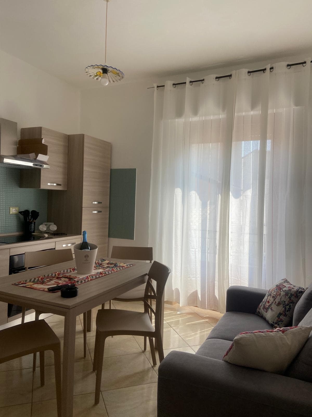 Living and dining area at dusk with table lamp glow